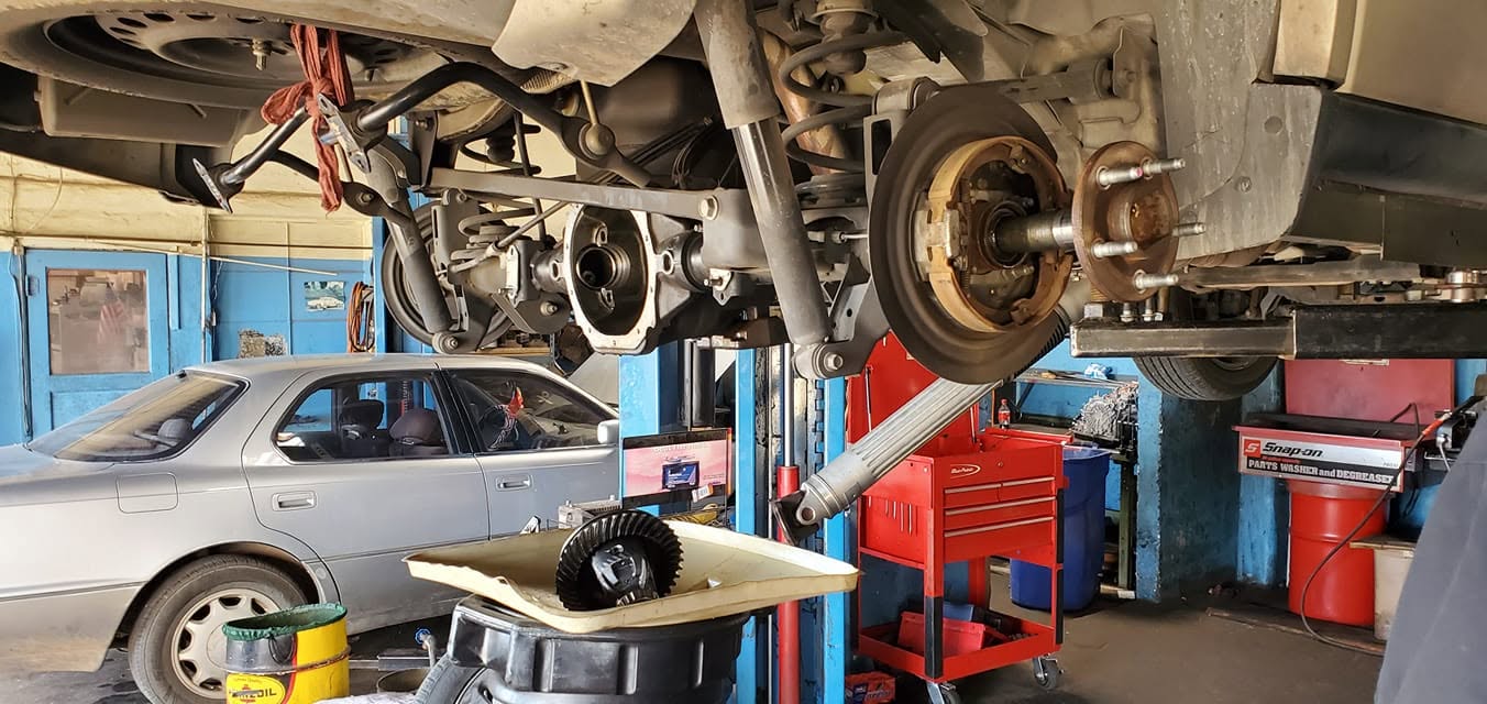 Vehicle on lift undergoing transmission service